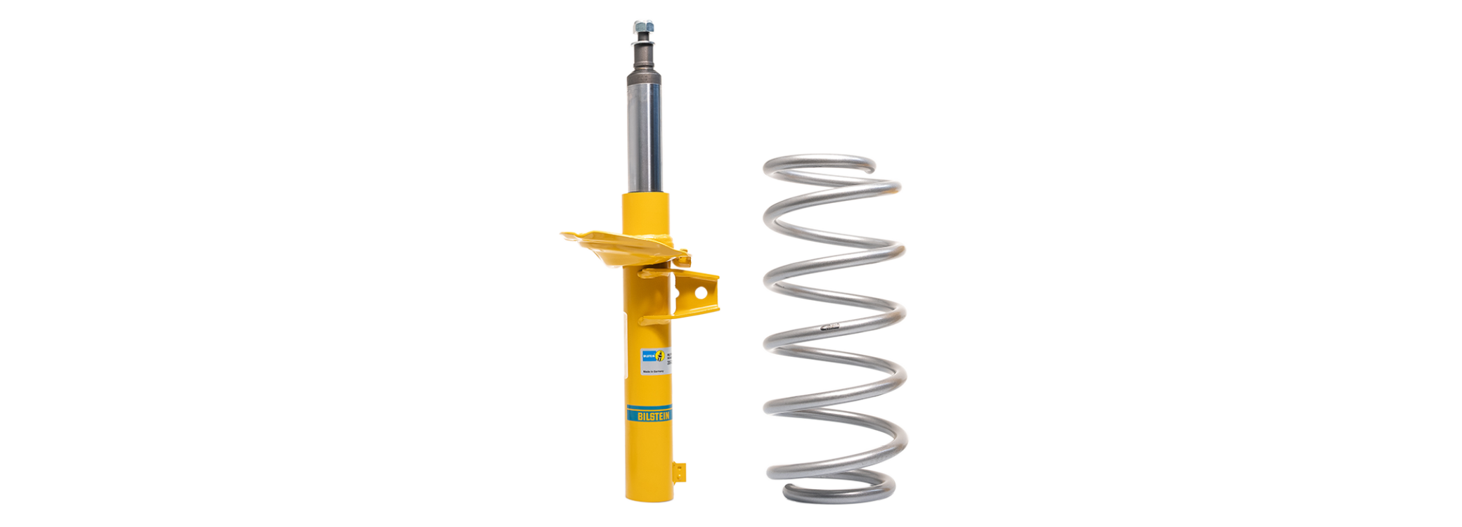 Ein gelber Bilstein-Stoßdämpfer und eine silberne Eibach-Schraubenfeder werden nebeneinander auf schwarzem Hintergrund angezeigt, wobei ein deutscher Text ihre Funktionen und Leistungsvorteile beschreibt.