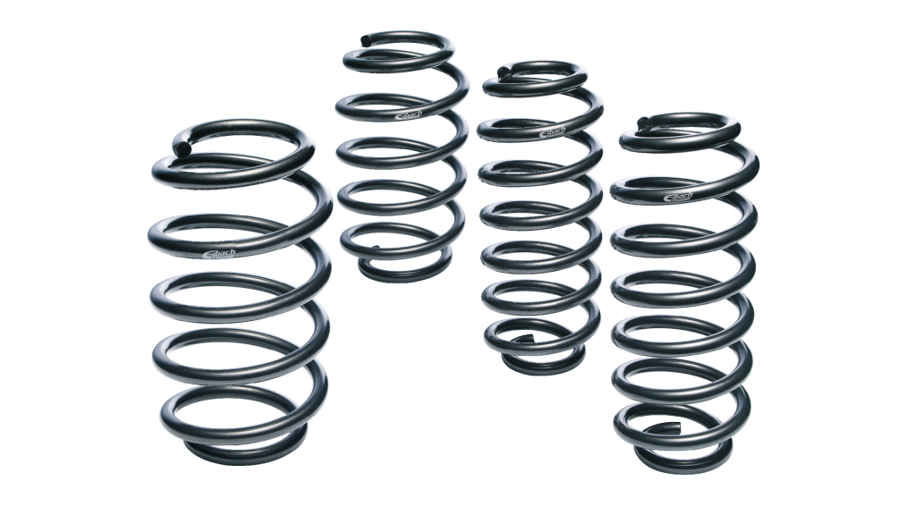Five black metal coil springs of varying heights and thicknesses, often used for suspension tuning or as vehicle lowering springs, are standing upright on a white background.