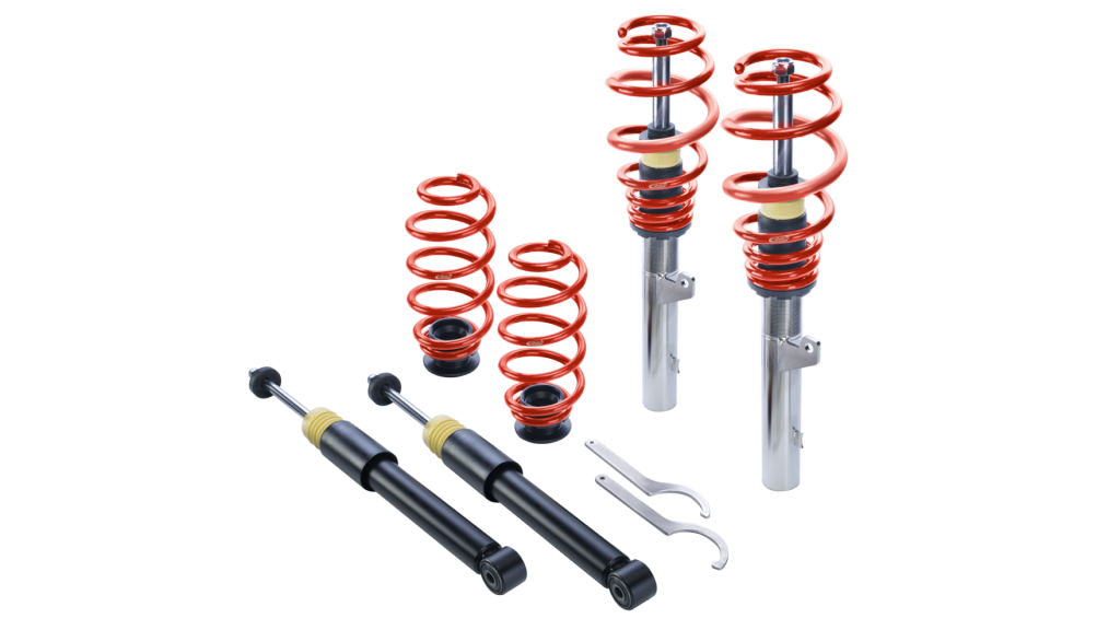 A set of height-adjustable suspension components for vehicle lowering, featuring red coil springs, silver shock absorbers with red springs, black shock absorbers, and two adjustment wrenches—all arranged on a white background.