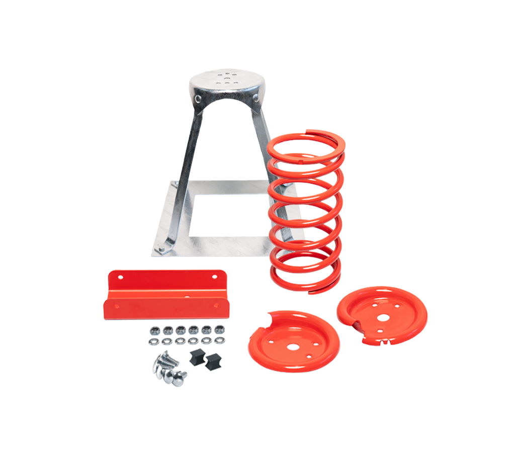 Ein Federkompressor-Bausatz aus Metall mit einem silbernen Ständer, einer großen roten Schraubenfeder, zwei roten runden Platten, einer roten Halterung und verschiedenen Schrauben, Muttern und Bolzen auf weißem Hintergrund.
